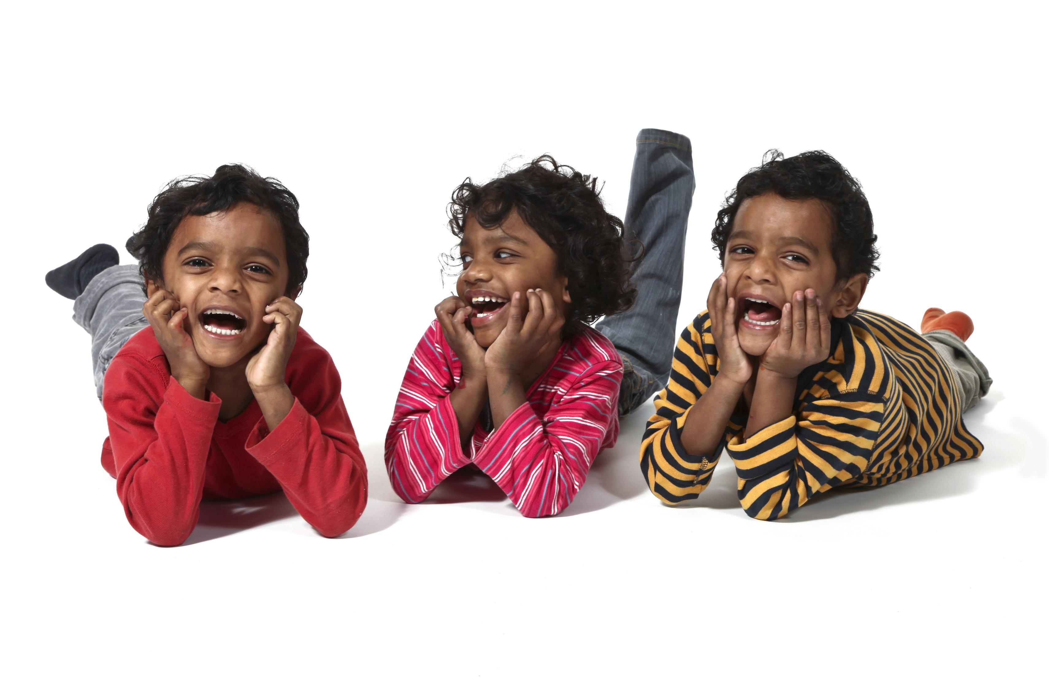 three small twins lying on a white background